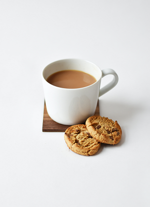 A mug of tea with two biscuits